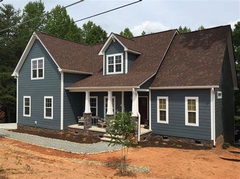 gray wood house with brown roof